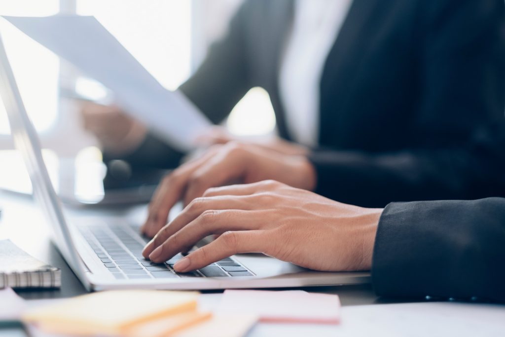 job seeker typing letter of intent for job application on the laptop