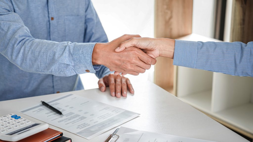 male candidate shaking hands with interviewer after a job interview